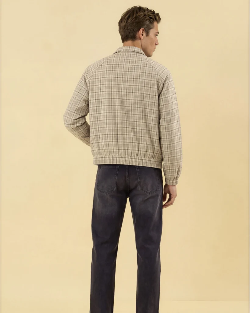 Back view of the Holvo Apricot Plaid Jacket with dark jeans